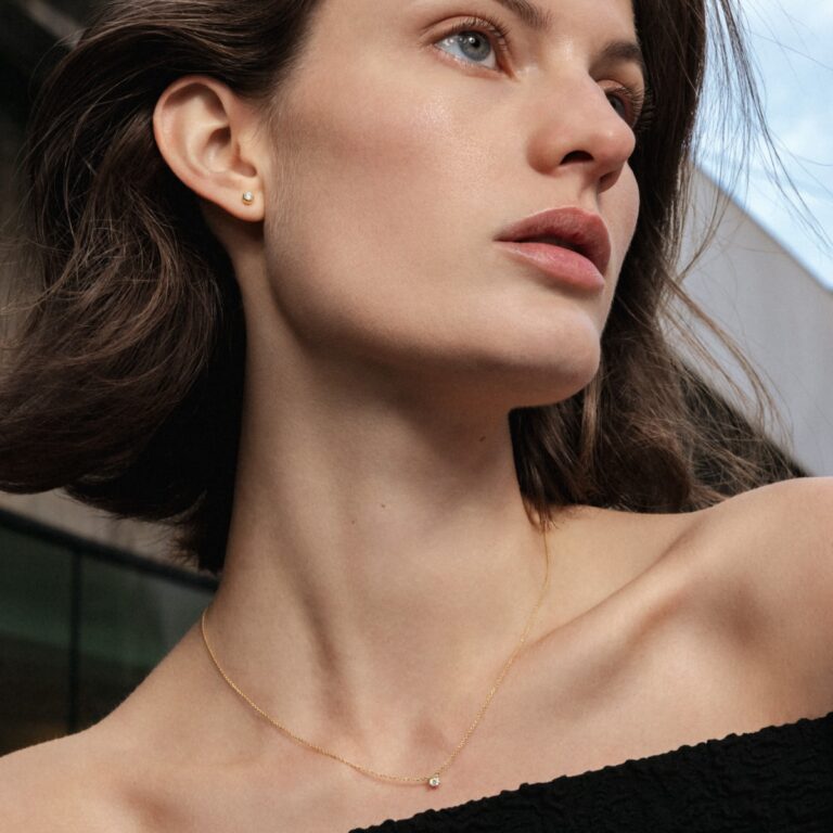 Georg Jensen “Signature solitaire” ørepynt i gult gull, mellom