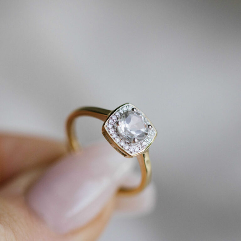 Ring i gult gull med hvit topas og diamanter
