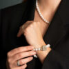 Ring med buer i kryss i gult og hvitt gull diamanter 0,50 ct