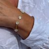 Georg Jensen “Daisy armbånd" i forgylt sølv med 8 hvite emaljerte blomster
